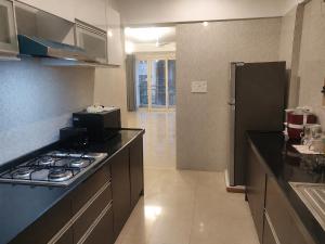 a kitchen with a stove and a counter top at 2BHK Luxurious Apt near BKC in Mumbai