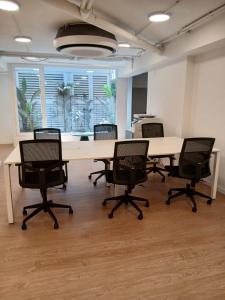 an office with a large table and chairs in a room at Smartr Valencia Turia in Valencia