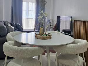 a white table and chairs with a basket on top at VFeel at Home- 2 BR Unit in Baguio