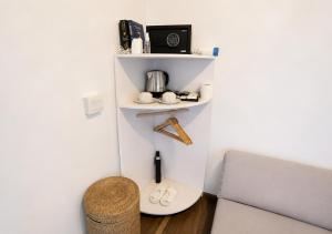 a room with a white wall with a shelf at Nunggalan Octopus 2 in Uluwatu