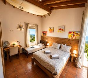 a bedroom with a bed and a desk and a table at Mayla Surf House in Aljezur