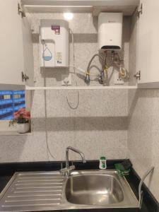 a kitchen sink with a soap dispenser above it at 2BHK Luxurious Apt near BKC in Mumbai +62 photos