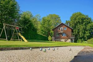 a house with a playground with balls on the ground at Le Milan Royal 26 pers, Malmedy, Balnéo, vue, calme in Malmedy