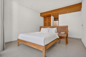 a bedroom with a large bed with a wooden headboard at Casa Cemagi by Orivista-LUX 3BR Tropical, 2 Min to Beach in Cemagi +28 photos