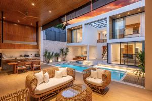 an open living room with a pool and a house at Casa Cemagi by Orivista-LUX 3BR Tropical, 2 Min to Beach in Cemagi