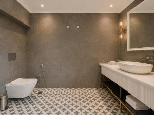 a bathroom with two sinks and a toilet in it at Chandralok - A Boutique Hotel in Udaipur Near Fateh Sagar Lake in Udaipur