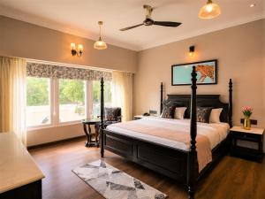 a bedroom with a large bed and a window at Chandralok - A Boutique Hotel in Udaipur Near Fateh Sagar Lake in Udaipur