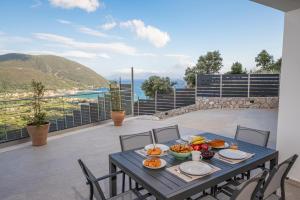 a blue table with food on top of a balcony at Aifantis Villa 2 in Póndi