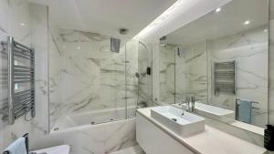 a white bathroom with a sink and a shower at Prime - Shared Pool - 6 Guests - Albufeira in Albufeira