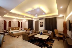 a large living room with a bed and a couch at Shanti Sewa Dham in Chhatikara