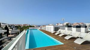 a swimming pool on the roof of a building at Prime - Shared Pool - 6 Guests - Albufeira in Albufeira +26 photos