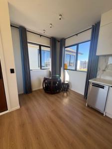 a living room with a table and some windows at 2 Bedroom Granny Flat in Runciman +3 photos