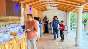 a group of people standing around a table with food at Dutch Bay Resort & Spa in Kalpitiya