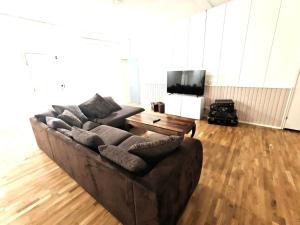 a living room with a couch and a tv at Reipas Ekonom Accommodation in Kotka
