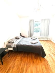 a bedroom with a bed and a wooden floor at Reipas Ekonom Accommodation in Kotka
