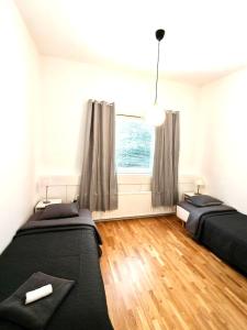 a bedroom with two beds and a window at Reipas Ekonom Accommodation in Kotka