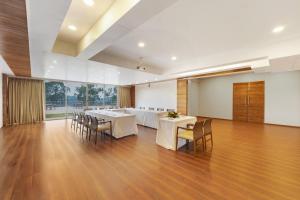 a large room with tables and chairs and a large window at Ayati Resort & Spa in Panchgani +31 photos