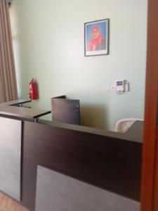 an office cubicle with a desk with a laptop on it at La Quinta Lodge in Mwanza