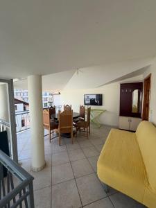 a living room with a bed and a table and chairs at Sun & Sea Shengjin in Lezhë