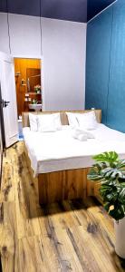 a bedroom with a large bed with white sheets at HALAL apartments in Tashkent city, Metro in Aktepa-Chigatay