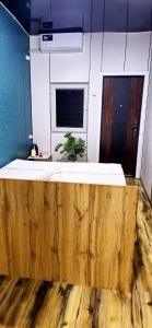 a large bed in a room with a wooden floor at HALAL apartments in Tashkent city, Metro in Aktepa-Chigatay