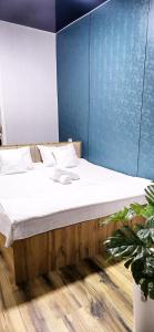 a bed in a room with a blue wall at HALAL apartments in Tashkent city, Metro in Aktepa-Chigatay +179 photos