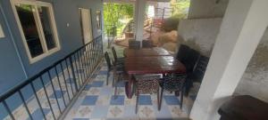 a porch with a table and chairs on a house at Steep Valley Resort in Kotagiri