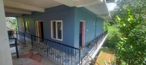 a blue house on the balcony of a house at Steep Valley Resort in Kotagiri
