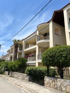an apartment building with a fence in front of it at KallitheaDeluxe in Kallithea Halkidikis