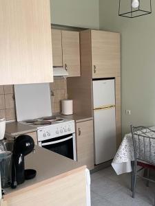 a kitchen with a stove and a refrigerator at Studio Nefeli - Heart of Archangelos in Archangelos +13 photos