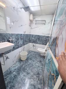 a bathroom with a toilet and a sink at Hotel Broadway Colaba in Mumbai