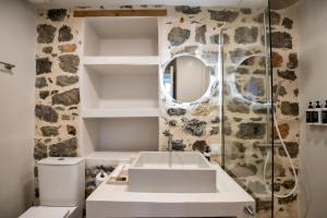 a bathroom with a sink and a mirror at Calais Boutique Apartments in Hydra +26 photos