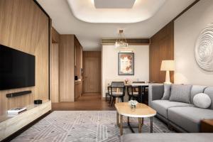 a living room with a couch and a table at Shangri-La Phnom Penh in Phnom Penh