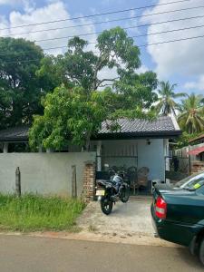 a motorcycle parked in front of a house at Lake Hostel Anuradhapura in Anuradhapura