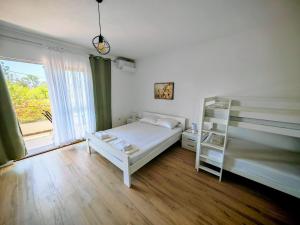 a bedroom with a bunk bed and a window at White apartments in Ulcinj