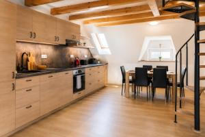 a kitchen with a table and a dining room at Ayni Apartment Semily in Bohemian Paradise in Semily