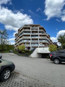 a large building with a car parked in front of it at Rooms in an Apartment with Beautiful Views in Przemyśl