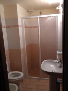 a bathroom with a shower and a toilet and a sink at Turris Morro di Rasiglia in Rasiglia