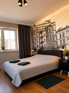 a bedroom with a large bed with a mural on the wall at Polka in Chojnice