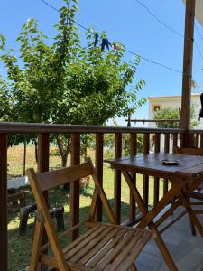 a wooden table and a chair on a deck at Dolphins House in Koinyra