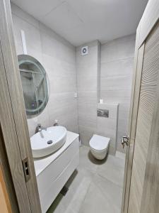 a white bathroom with a sink and a toilet at Apartman Kiki in Šušanj +48 photos