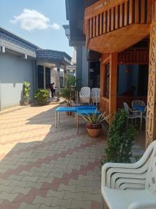 a patio with a blue table and chairs at La Quinta Lodge in Mwanza