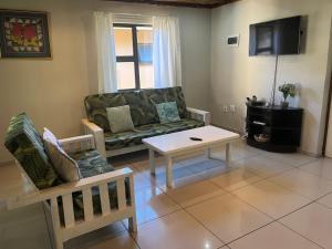 a living room with a couch and a coffee table at Ingwenya Chalet in Sodwana Bay