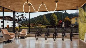 a group of bikes on a balcony with mountains in the background at Familotel Kindl in Neustift im Stubaital