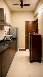 a kitchen with a refrigerator and a stove at Coutinho BNB in Madgaon +1 photo