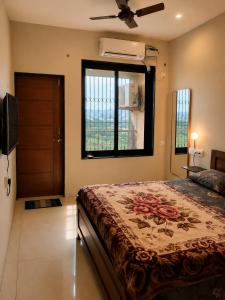 a bedroom with a bed and a window at Coutinho BNB in Madgaon