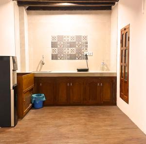 a kitchen with a large sink and a refrigerator at Newa Inn Homestay in Kathmandu +84 photos