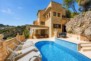 a villa with a swimming pool in front of a house at Port Andratx - 3444-29 Mallorca in Port d'Andratx
