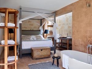 a bedroom with a bed and a bath tub at Kasbah 3 in Cala Vadella +54 photos