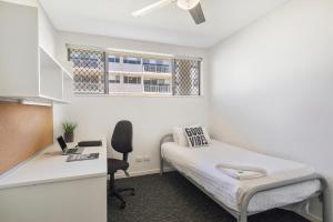 a small room with a bed and a desk at Murdoch University Village in Perth